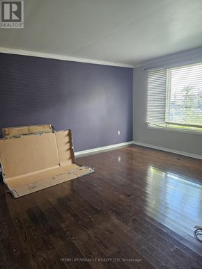 Hamilton (Gilkson) apartment for rent - A room with a wooden floor and a cardboard box on it.