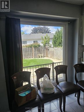 Hamilton (Gilkson) apartment for rent - Two chairs are in front of a window with a view of a fence and a house.