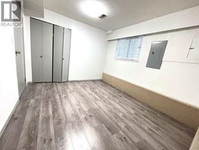 Vancouver apartment for rent - A room with a wood floor and a window with blinds.