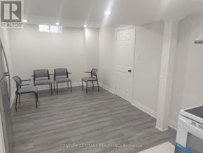 Toronto (Rouge) apartment for rent - A realtor photo of a room with grey chairs and a wooden floor.
