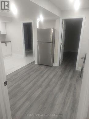 Toronto (Rouge) apartment for rent - A grey fridge in a white room with a door open.