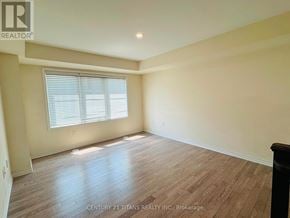 Toronto (Clairlea-Birchmount) townhouse for rent - A spacious room with wooden flooring and a window with blinds.