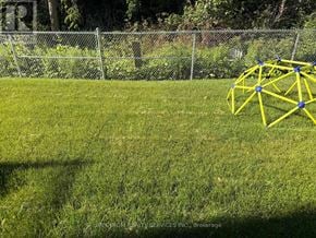 Barrie (Innis-Shore) townhouse for rent - A yellow geometric structure sits on a grassy field.