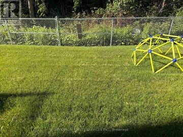 Barrie (Innis-Shore) townhouse for rent - A yellow geometric structure sits on a grassy field.
