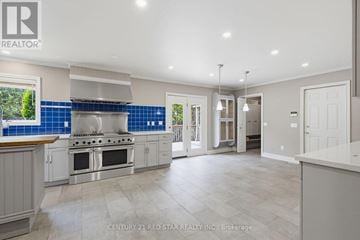 Caledon apartment for rent - A spacious kitchen with a stove top oven and a blue backsplash.