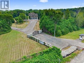 Caledon apartment for rent - A large house with a driveway and a fence in front of it.