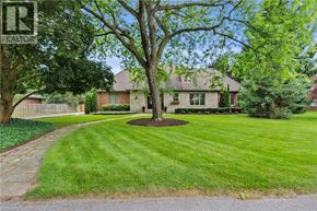 Niagara-On-The-Lake apartment for rent - A house with a lawn and a tree in front of it.