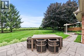Niagara-On-The-Lake apartment for rent - A backyard with a table and chairs set up.