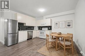 Ottawa apartment for rent - A kitchen with a table and chairs in the middle of the room.