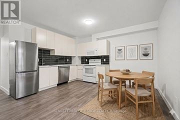 Ottawa apartment for rent - A kitchen with a table and chairs in the middle of the room.