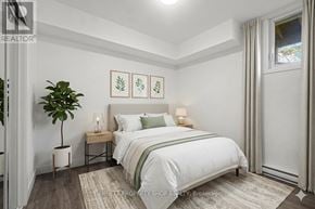 Ottawa apartment for rent - A bedroom with a bed, nightstands, and a plant.