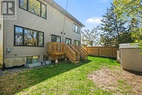 Ottawa apartment for rent - A house with a deck and a fence in the backyard.