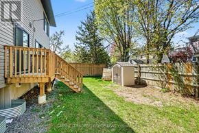 Ottawa apartment for rent - A backyard with a wooden deck and a shed.