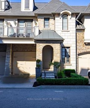St. Catharines (Glendale/Glenridge) townhouse for rent - A large house with a balcony and a garage door.