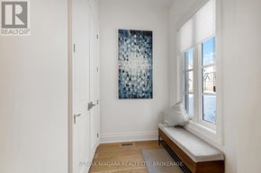 St. Catharines (Glendale/Glenridge) townhouse for rent - A room with a bench and a painting on the wall.