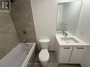 Toronto (Moss Park) condo for rent - A bathroom with a toilet, sink, and bathtub.