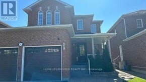Vaughan (Maple) apartment for rent - A brick house with a sign that says "REALTOR" on the top left corner.