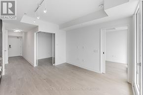 Mississauga (City Centre) condo for rent - A spacious, empty room with white walls and wooden flooring.