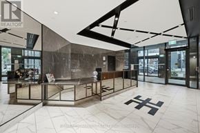 Toronto (Waterfront Communities) condo for rent - A modern office lobby with a glass wall and a reception desk.