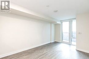 Toronto (Clanton Park) condo for rent - A spacious room with a sliding glass door leading to a balcony.