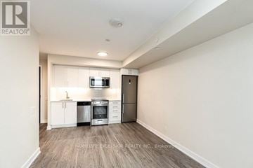 Toronto (Clanton Park) condo for rent - A well-lit kitchen with white cabinets and stainless steel appliances.