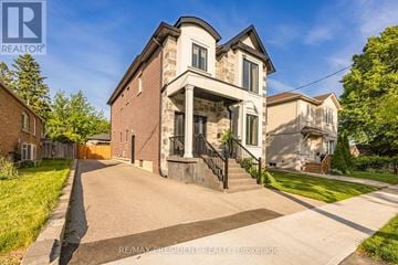 Toronto (Clairlea-Birchmount) apartment for rent - A house with a driveway in front of it.