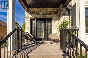 Toronto (Clairlea-Birchmount) apartment for rent - A house entrance with a glass door and a stone pillar.