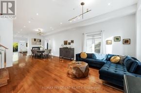Toronto (Clairlea-Birchmount) apartment for rent - A living room with a dark blue couch and wooden floors.