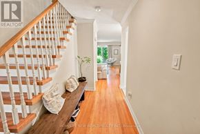 Mississauga (Cooksville) apartment for rent - A hallway with a wooden bench and a staircase.