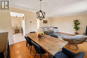 Mississauga (Cooksville) apartment for rent - A modern dining room with a wooden table and chairs.