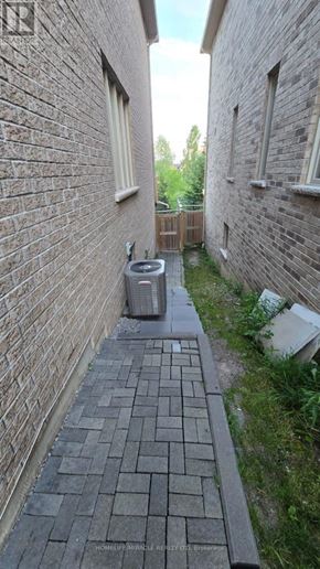 Ajax (Northwest Ajax) apartment for rent - A narrow alley with a brick wall and a tiled floor.