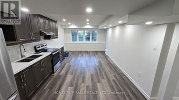 Ajax (Northwest Ajax) apartment for rent - A spacious kitchen with dark wood flooring and white walls.
