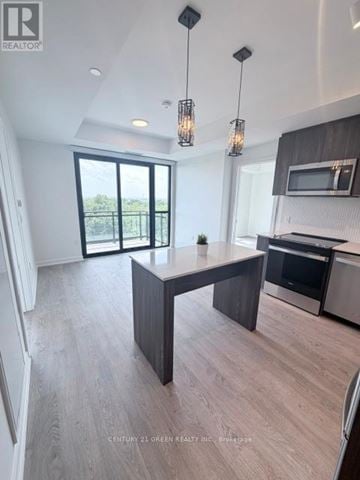 Milton (Cb Cobban) house for rent - A modern kitchen with a large island and a microwave above it.