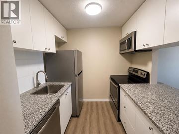 Lethbridge apartment for rent - A kitchen with granite countertops and stainless steel appliances.