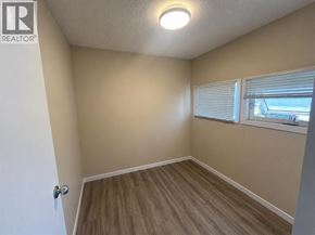Lethbridge apartment for rent - A room with a door, window, and wooden flooring.