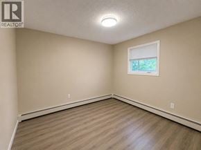 Lethbridge apartment for rent - A room with a window and wooden flooring.