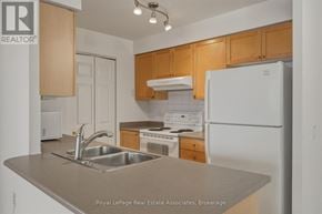 Mississauga (Hurontario) condo for rent - A kitchen with a sink and a refrigerator.
