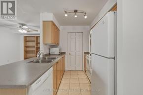 Mississauga (Hurontario) condo for rent - A kitchen with a sink, refrigerator, and cabinets.