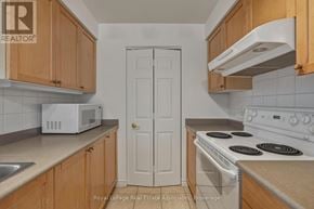 Mississauga (Hurontario) condo for rent - A white door is in the middle of a kitchen.