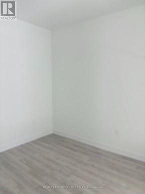 Toronto (Waterfront Communities) condo for rent - A room with a wooden floor and white walls.