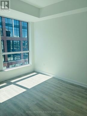 Toronto (Waterfront Communities) condo for rent - A room with a large window and wooden flooring.