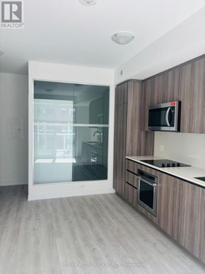 Toronto (Waterfront Communities) condo for rent - A modern kitchen with a microwave above the stove.