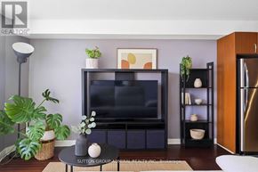 Toronto (Waterfront Communities) condo for rent - A living room with a flat screen TV and a plant on the side.