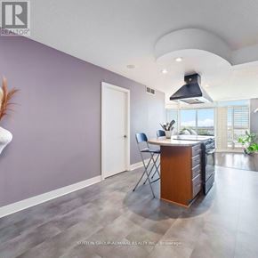 Toronto (Waterfront Communities) condo for rent - A kitchen with a purple wall and a wooden island.