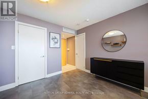 Toronto (Waterfront Communities) condo for rent - A hallway with a white door, a mirror, and a black bench.