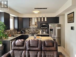Ajax (Northwest Ajax) apartment for rent - A brown leather couch is in the middle of a modern kitchen.