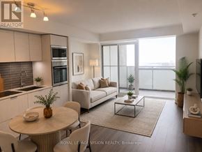 Toronto (Waterfront Communities) condo for rent - A well-lit, modern living room with a dining table and chairs, a sofa, and a kitchen area with a stove and oven.