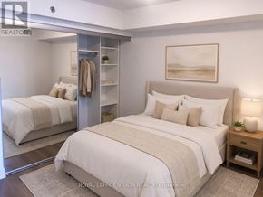 Toronto (Waterfront Communities) condo for rent - A bedroom with a large bed, a nightstand, and a mirror.