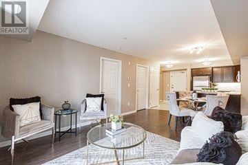Milton (Wi Willmott) condo for rent - A living room with a glass coffee table and a couch with a throw pillow.