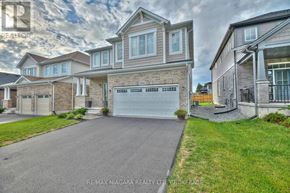 Fort Erie (Ridgeway) apartment for rent - A large, modern house with a driveway in front is for sale.